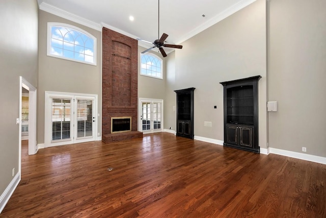 unfurnished living room featuring dark wood finished floors, a fireplace, and ornamental molding