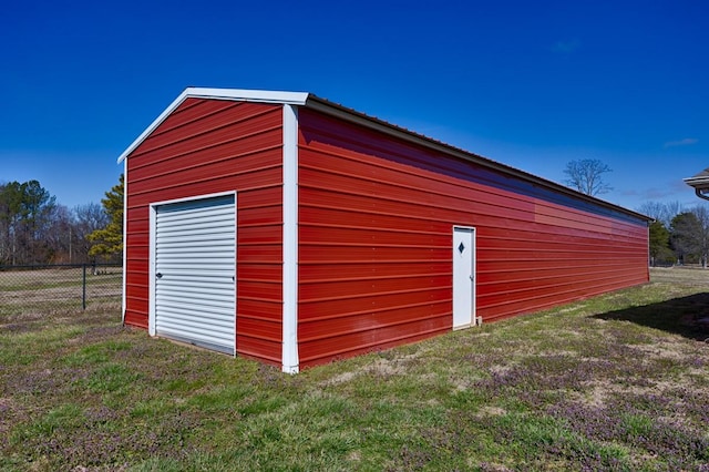 view of outbuilding featuring an outbuilding and fence