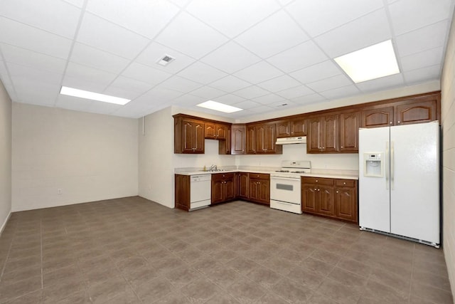 kitchen featuring white appliances, light countertops, visible vents, and under cabinet range hood