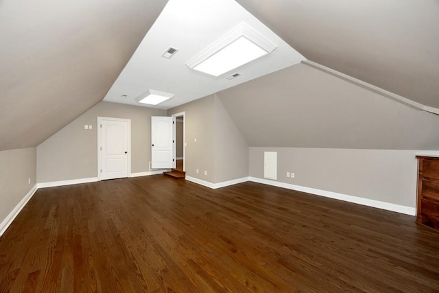 bonus room featuring visible vents, baseboards, and dark wood-style flooring