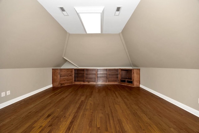 bonus room featuring visible vents, baseboards, dark wood-type flooring, and lofted ceiling