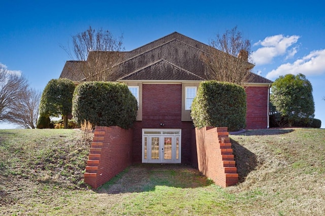 view of front of house featuring brick siding and french doors