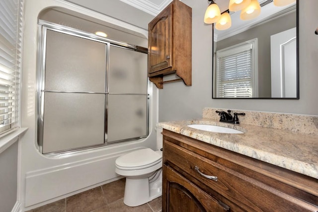 full bath with tile patterned floors, combined bath / shower with glass door, toilet, and vanity