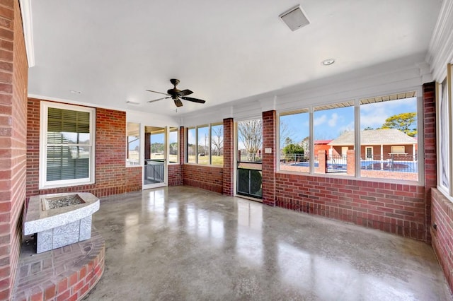 sunroom / solarium with a ceiling fan