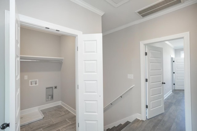 clothes washing area featuring visible vents, wood finish floors, electric dryer hookup, washer hookup, and crown molding