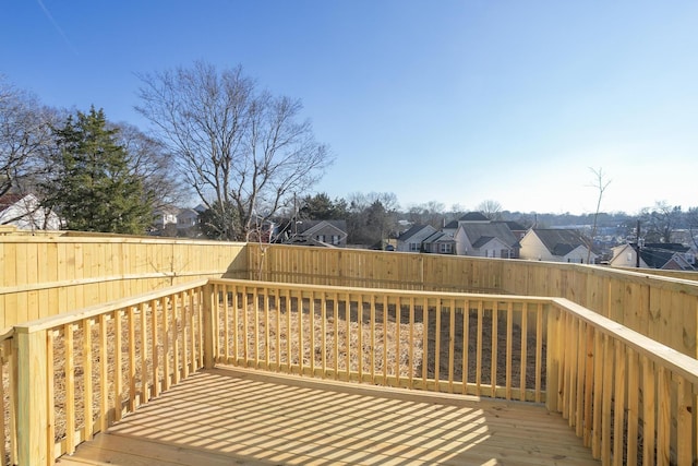 wooden terrace with a fenced backyard and a residential view