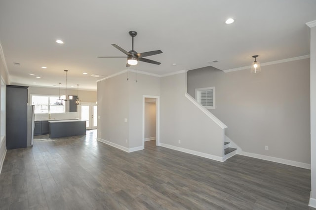 unfurnished living room with dark wood finished floors, stairway, baseboards, and ornamental molding