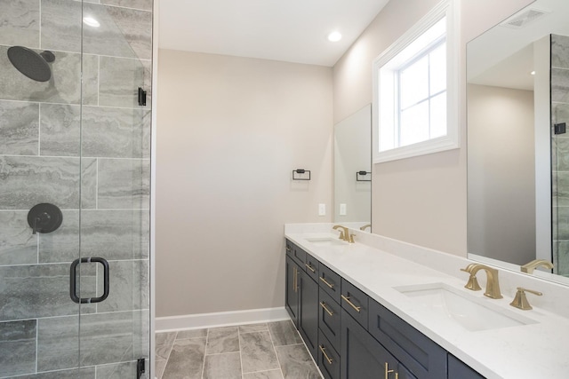 full bathroom featuring visible vents, a shower stall, baseboards, and a sink