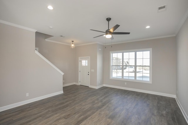 foyer entrance with visible vents, crown molding, and baseboards