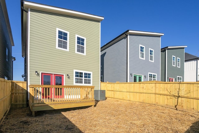 rear view of property with a deck and a fenced backyard