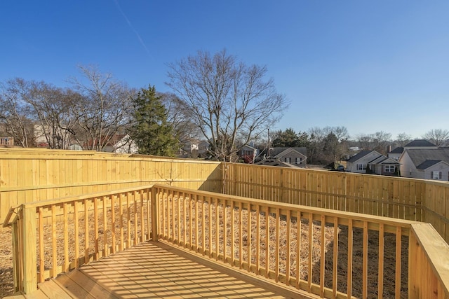 deck featuring a residential view and a fenced backyard