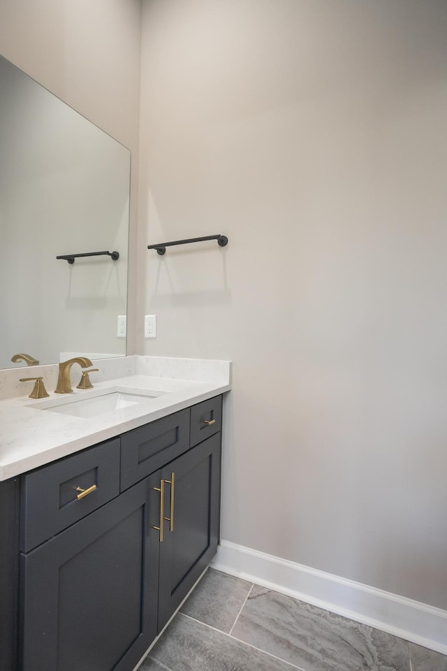 bathroom featuring vanity and baseboards