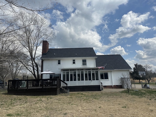 back of house with a wooden deck, a yard, a sunroom, a chimney, and crawl space