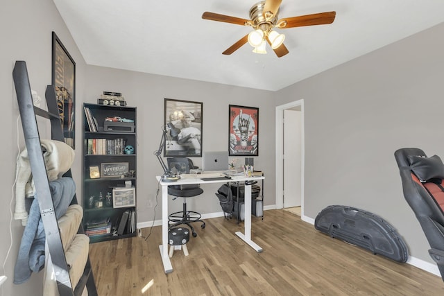 office featuring a ceiling fan, baseboards, and wood finished floors