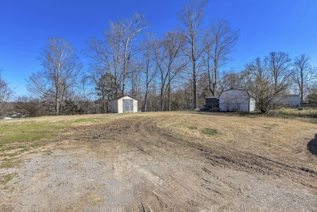 view of yard featuring an outbuilding and a storage shed