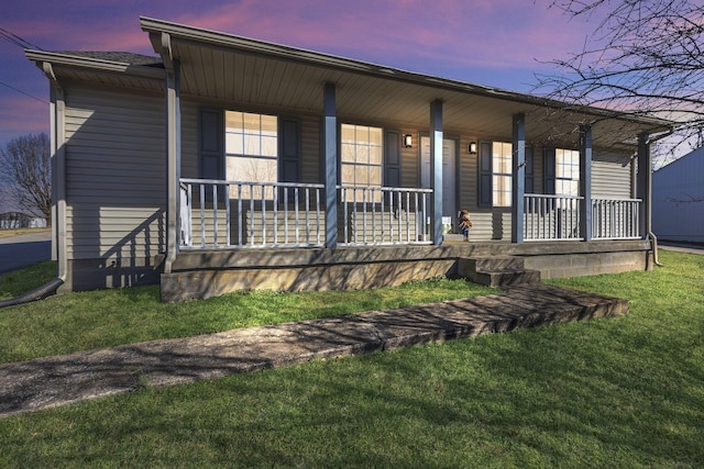 view of front of home with a porch and a front yard