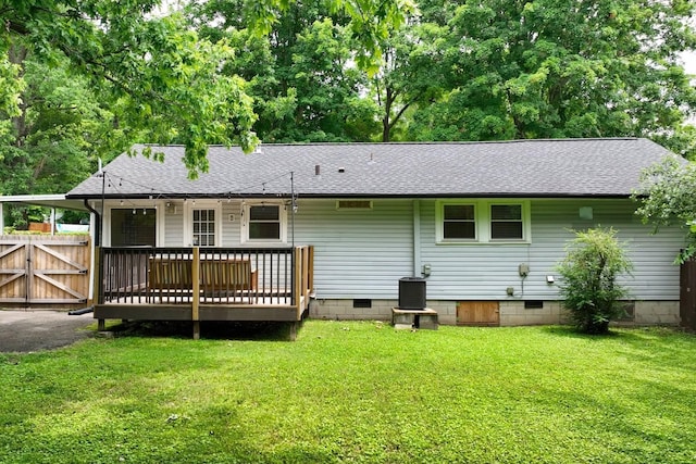 back of property with crawl space, central AC unit, a lawn, and a shingled roof