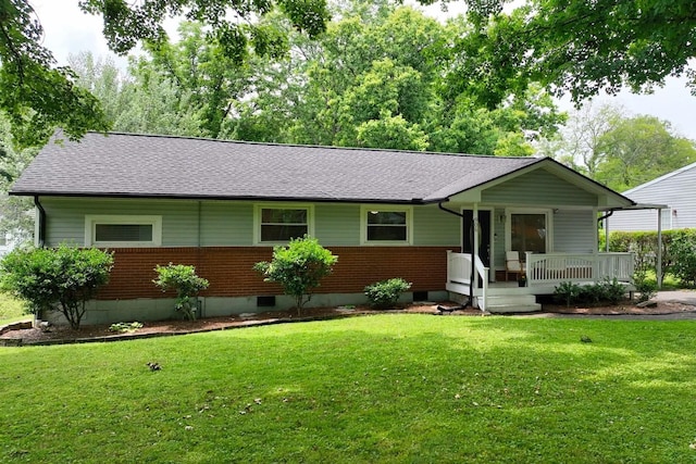 ranch-style home featuring brick siding, covered porch, a front lawn, and a shingled roof