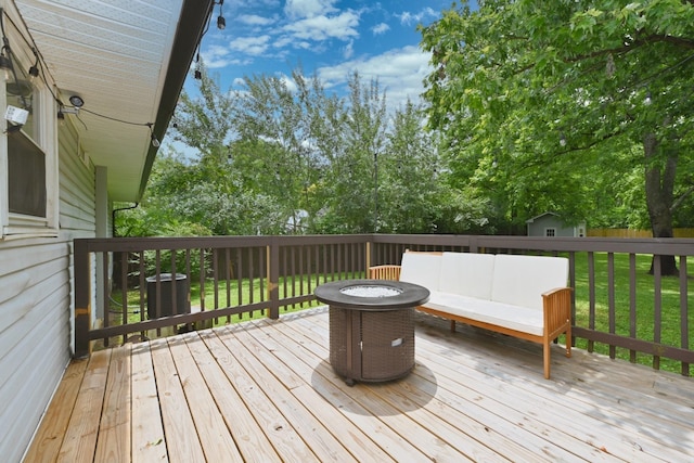 deck featuring an outdoor living space, a lawn, and central AC