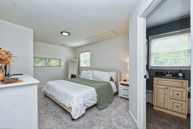 bedroom featuring dark colored carpet, baseboards, and attic access