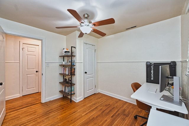 office featuring visible vents, ceiling fan, baseboards, and wood finished floors