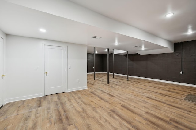 finished below grade area with visible vents, recessed lighting, baseboards, and wood finished floors