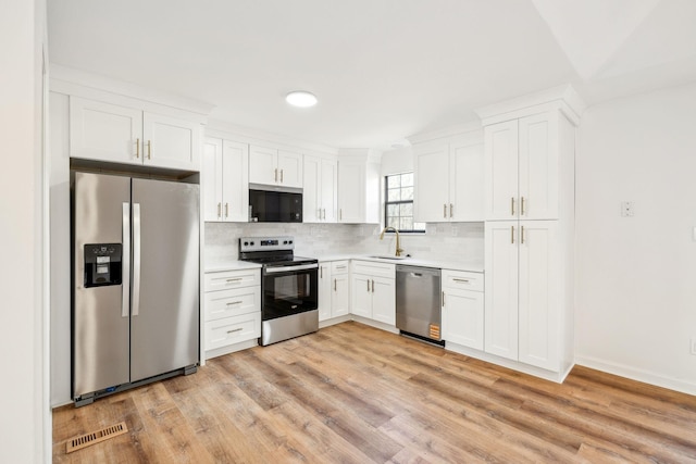 kitchen featuring a sink, light countertops, visible vents, and stainless steel appliances