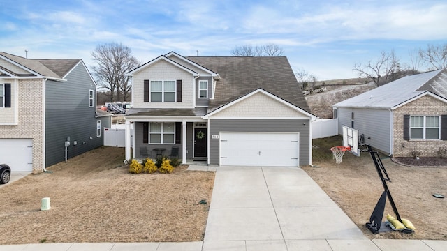 view of front of home featuring driveway, fence, covered porch, an attached garage, and a shingled roof