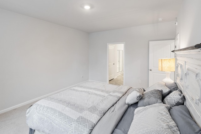 bedroom featuring baseboards and light carpet