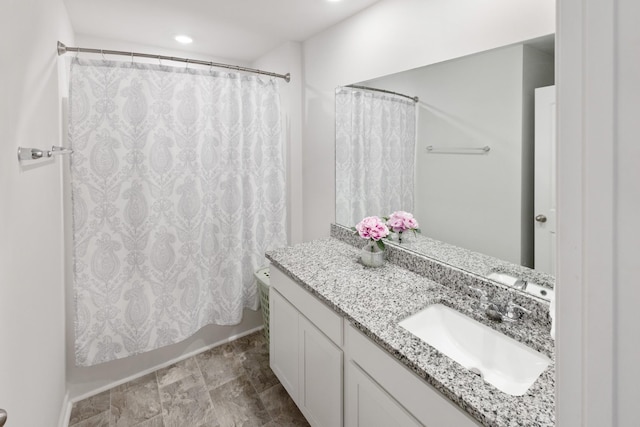 bathroom featuring recessed lighting and vanity