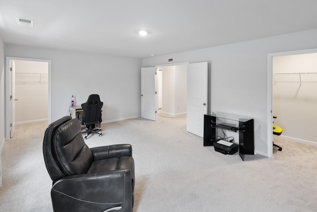 living area featuring visible vents, baseboards, and carpet