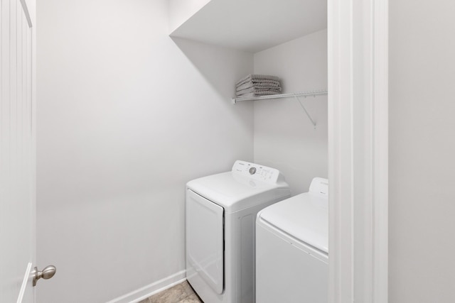 laundry area with washer and dryer, baseboards, and laundry area