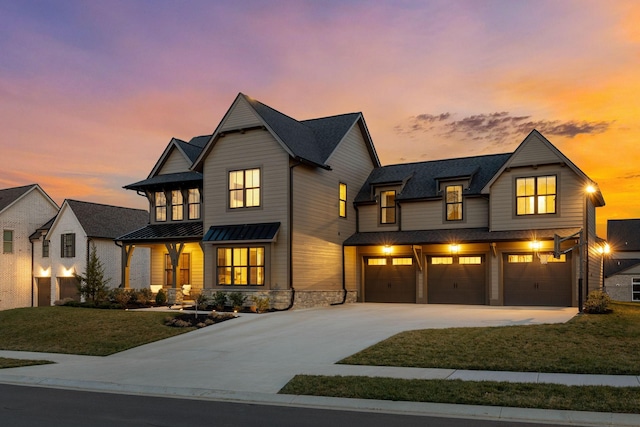 modern farmhouse style home with a lawn, a garage, driveway, a standing seam roof, and metal roof