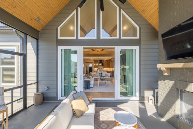 exterior space with vaulted ceiling, an outdoor fireplace, and wood ceiling