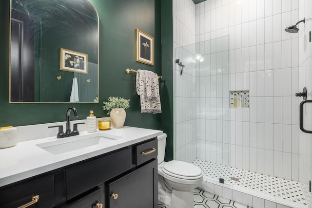 full bathroom featuring a stall shower, toilet, and vanity