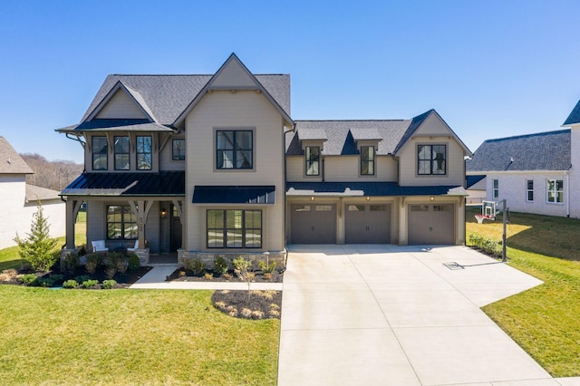 view of front of property with a standing seam roof, an attached garage, concrete driveway, and a front lawn