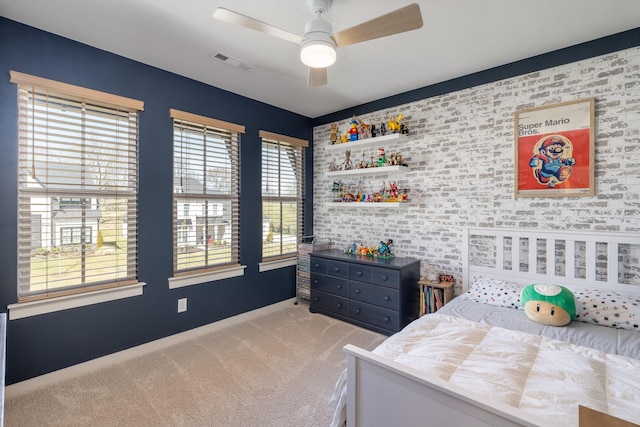 bedroom with carpet flooring, visible vents, and ceiling fan