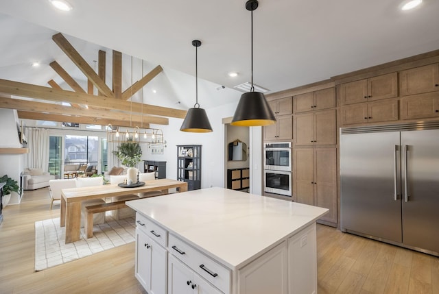 kitchen featuring a kitchen island, light wood-style flooring, stainless steel appliances, and lofted ceiling