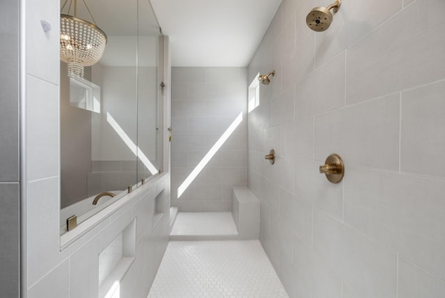 bathroom with tile patterned flooring and a tile shower