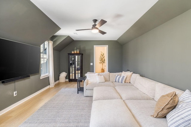 living room featuring baseboards, a ceiling fan, lofted ceiling, and wood finished floors