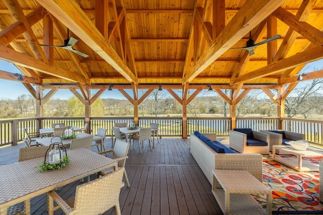 wooden deck featuring a gazebo, outdoor dining area, ceiling fan, and outdoor lounge area