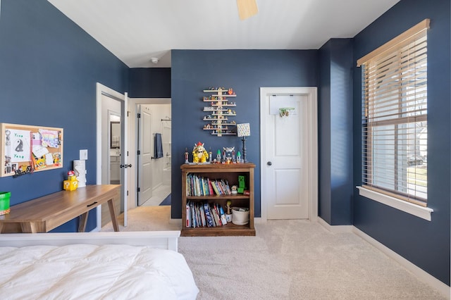 carpeted bedroom with a ceiling fan and baseboards