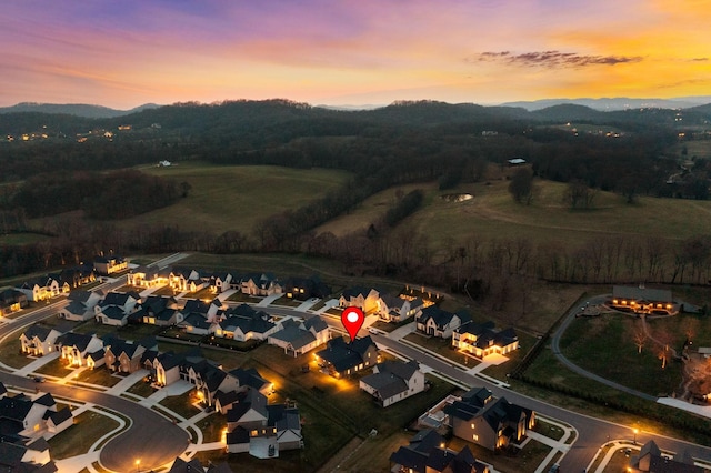 aerial view at dusk featuring a residential view and a mountain view