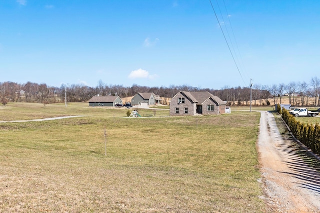 view of yard with dirt driveway