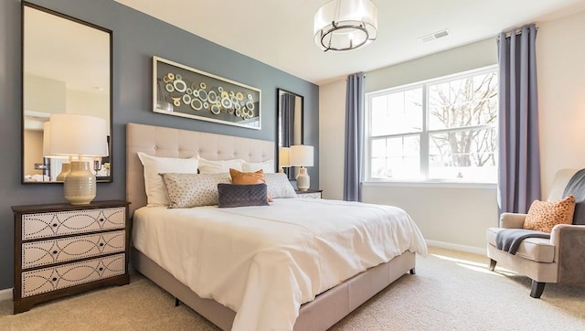 carpeted bedroom with baseboards and visible vents