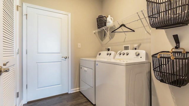 washroom featuring dark wood finished floors, laundry area, and washing machine and clothes dryer