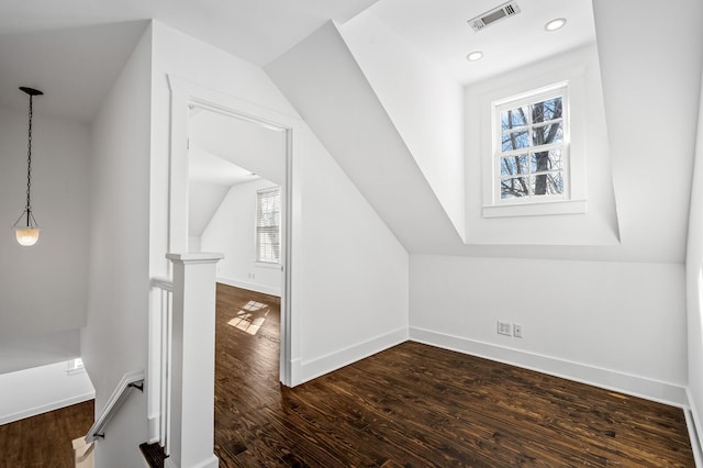 additional living space with dark wood-style floors, visible vents, baseboards, lofted ceiling, and recessed lighting