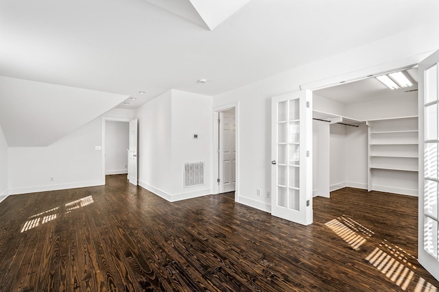 interior space with visible vents, baseboards, and wood finished floors