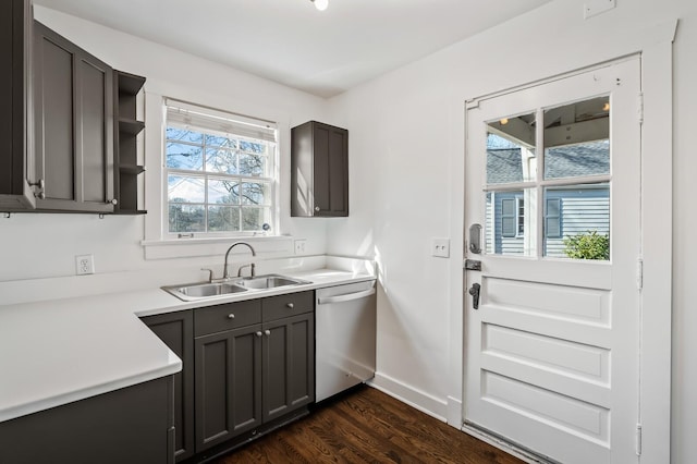 kitchen with open shelves, dark wood-type flooring, baseboards, stainless steel dishwasher, and a sink