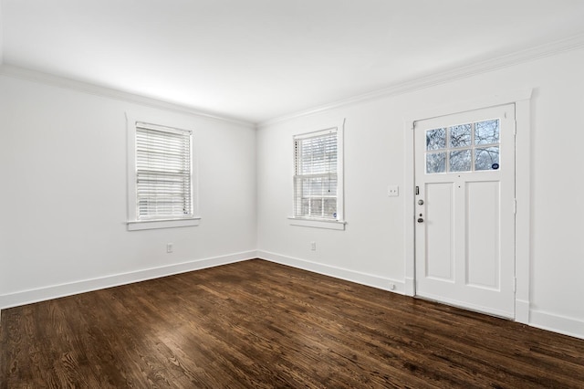 entryway with dark wood-type flooring, baseboards, and ornamental molding